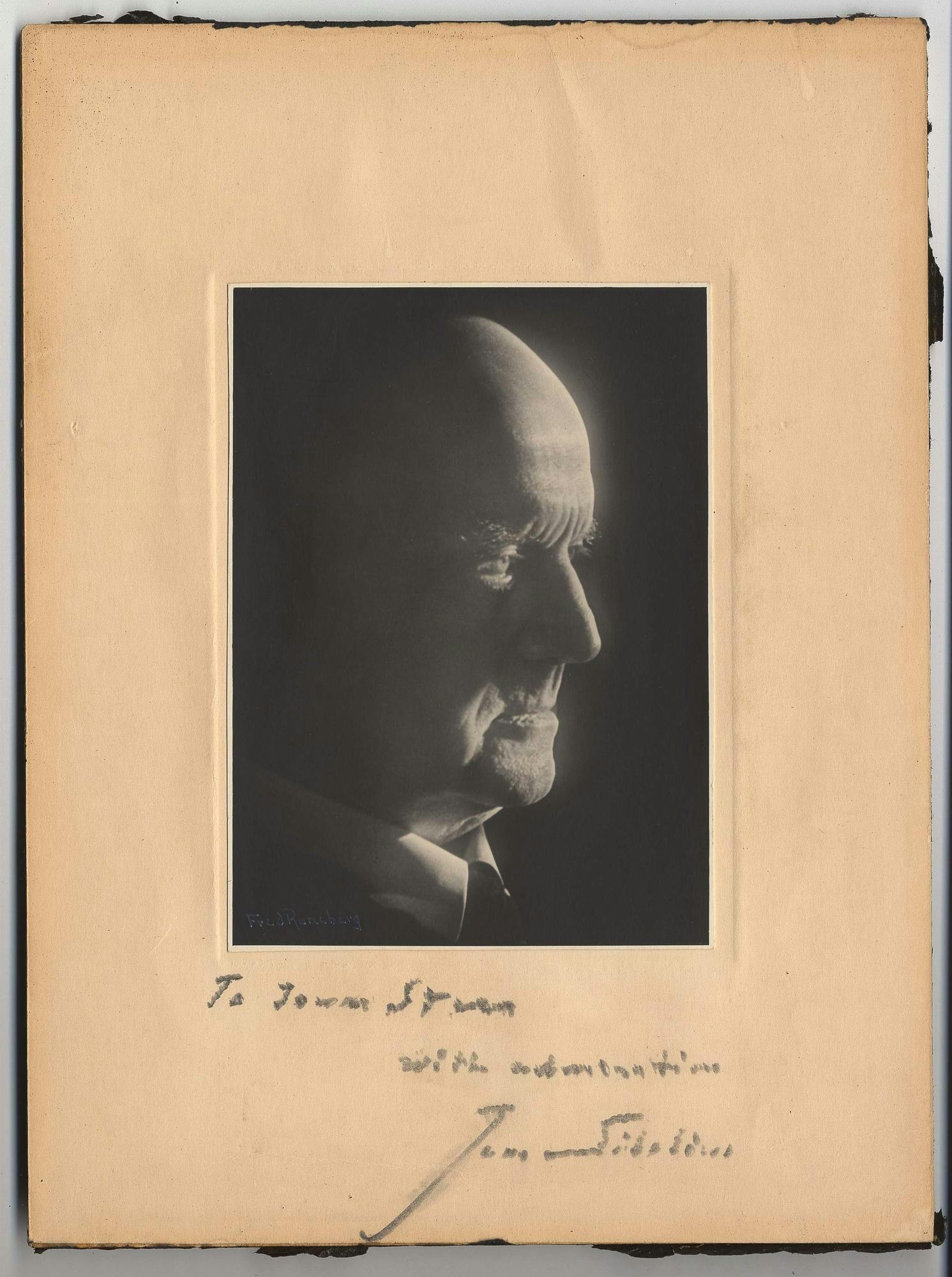 A dark photo of Sibelius in profile pasted to a paper inscribed to Isaac Stern