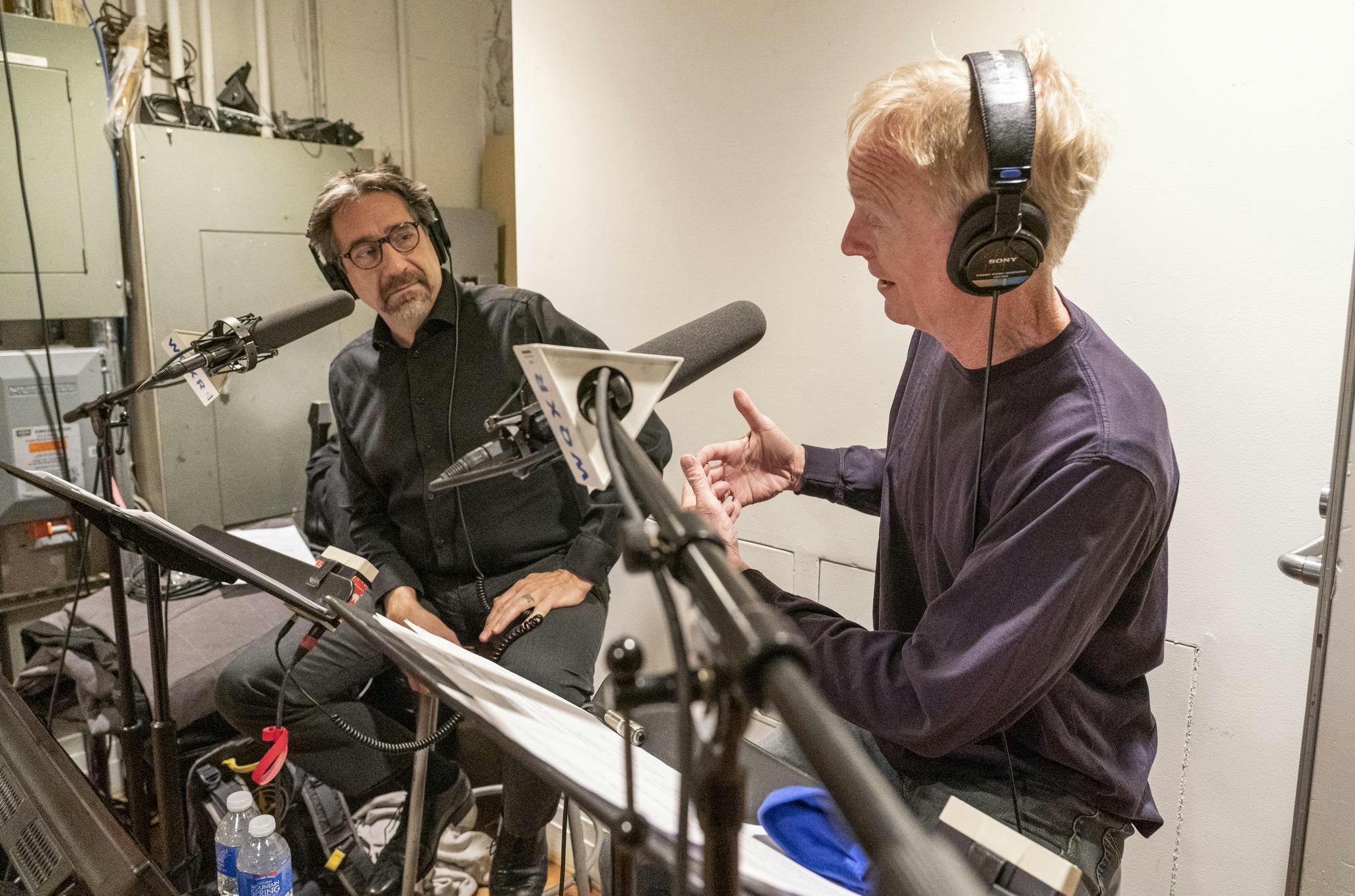 Jeff Spurgeon and John Schaefer recording backstage with their notes and equipment