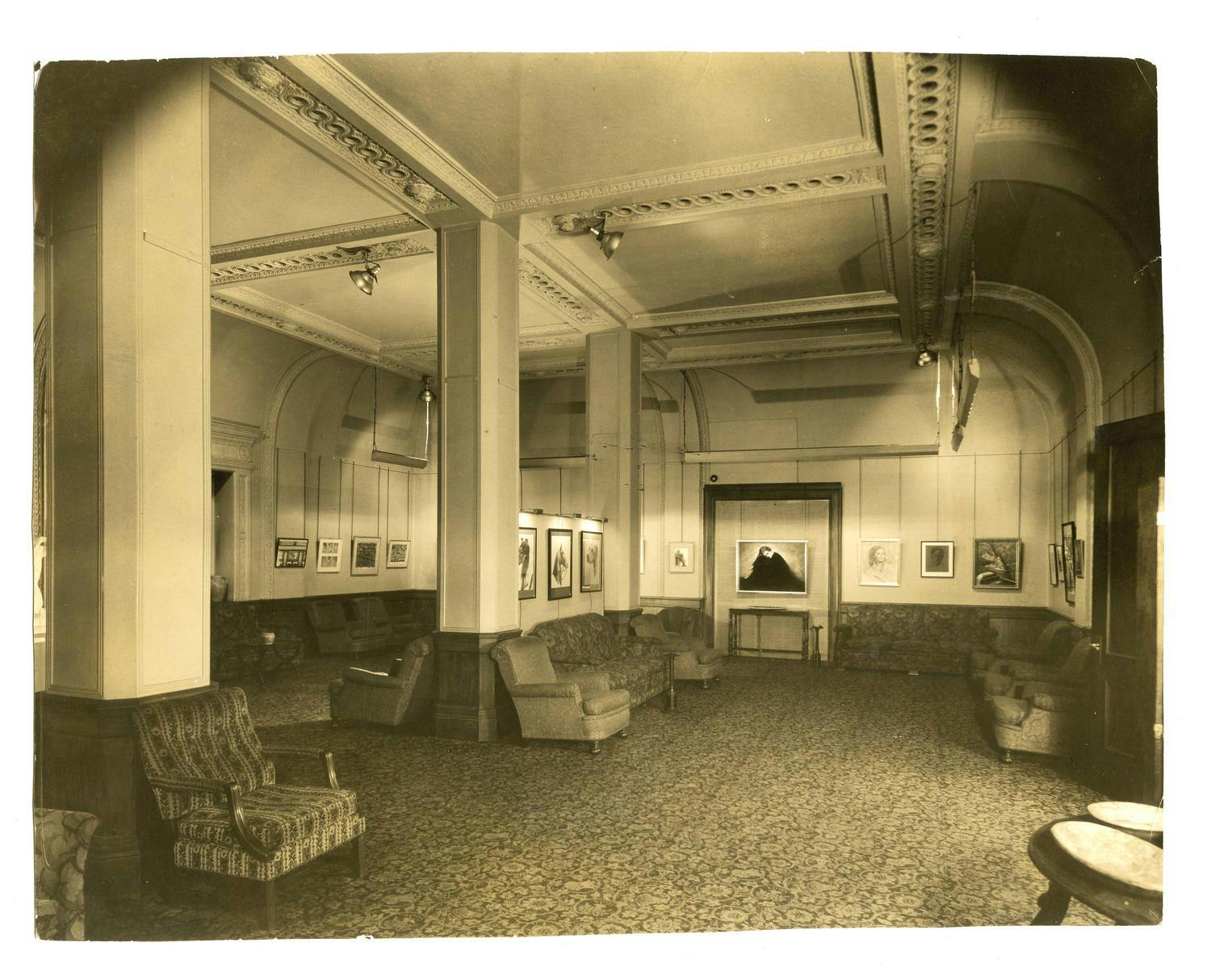 The Art Gallery with decorative couches and paintings on the walls