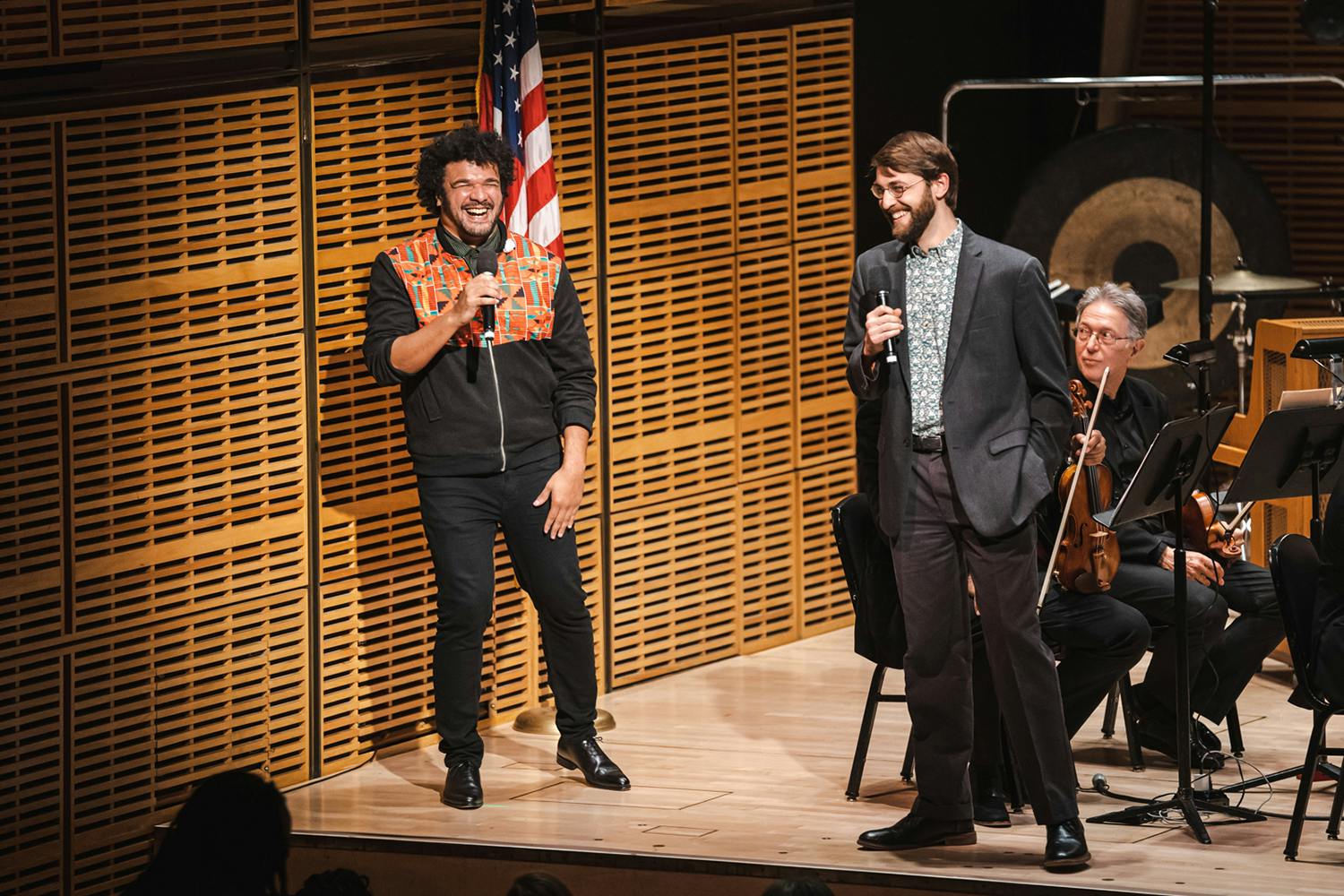 A laughing Curtis Stewart on stage with Jack Hughes