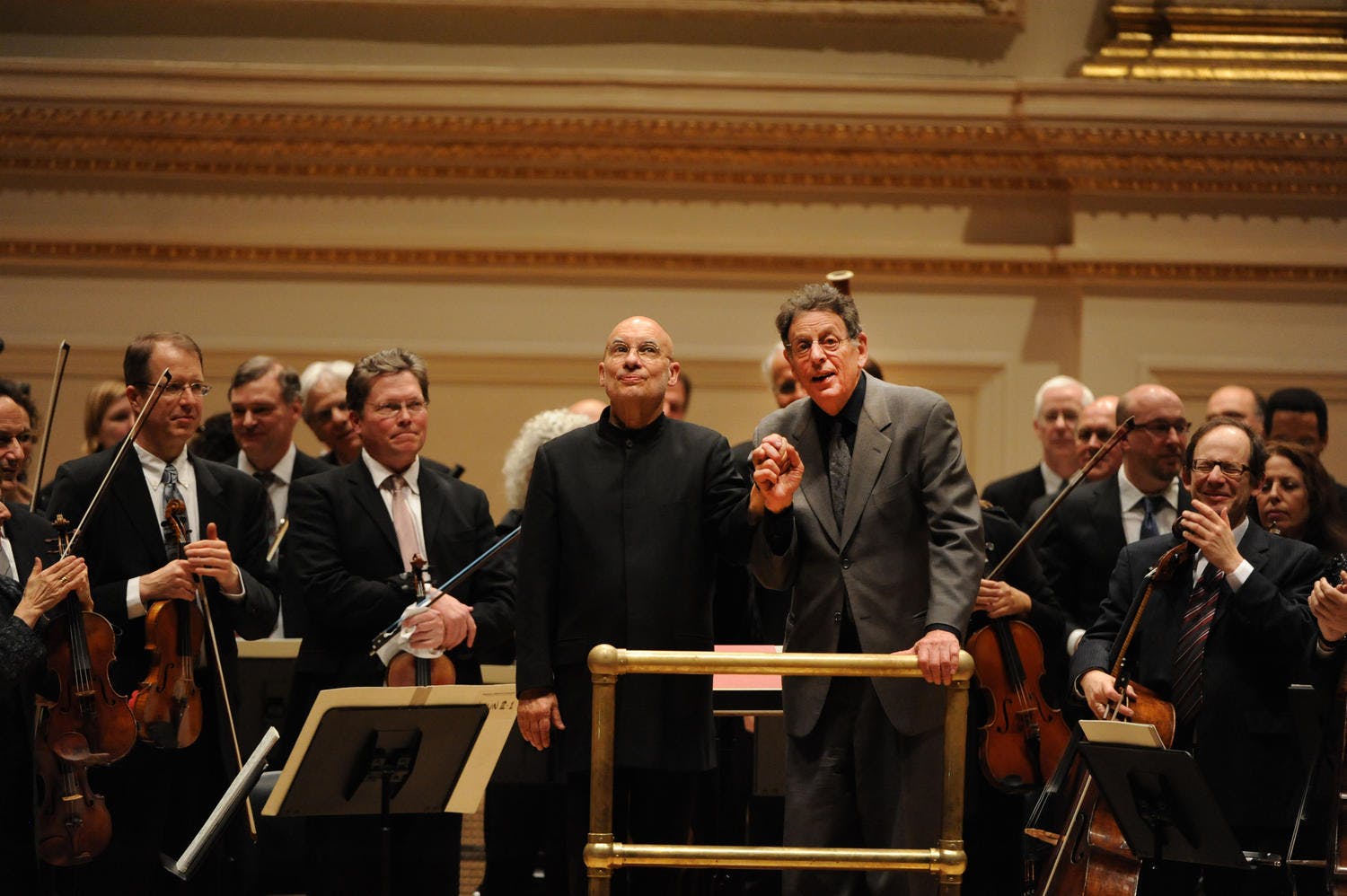 Dennis Russell Davies and Philip Glass on stage with the orchestra