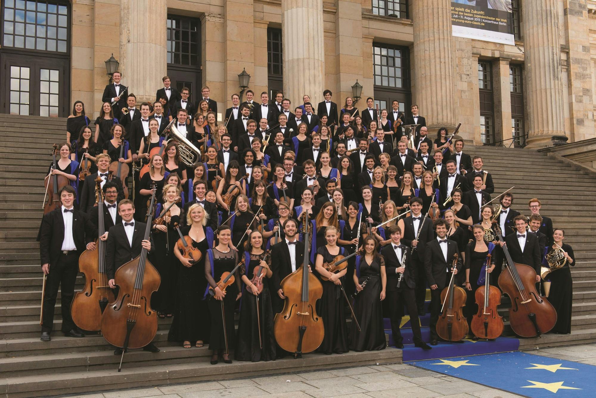 The European Union Youth Orchestra posing outside on stairs