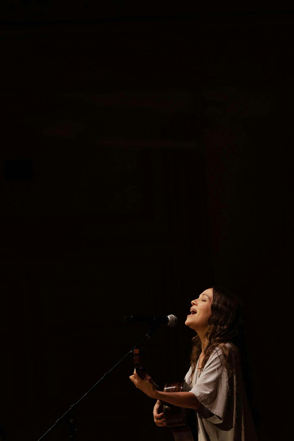 Natalia Lafourcade playing the guitar onstage at Carnegie Hall