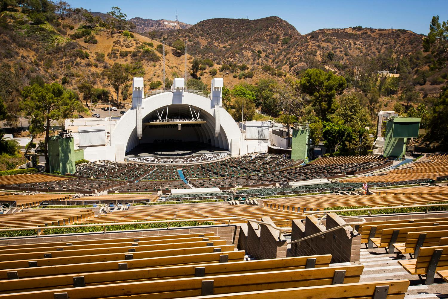 Amphitheater in front of mountains with rows of seats.