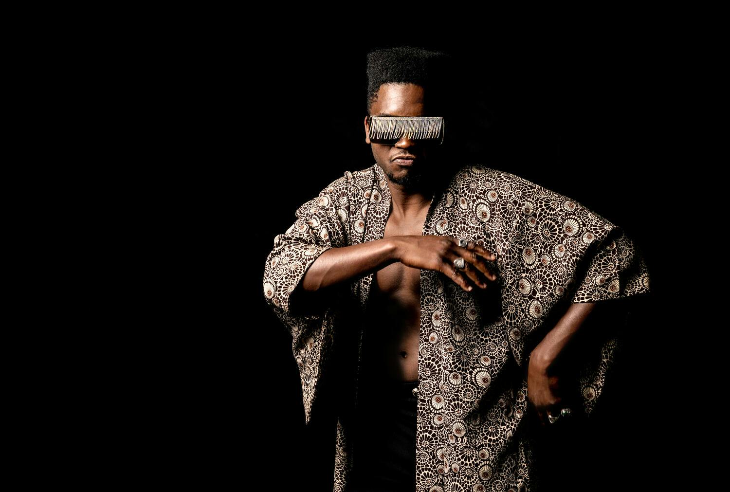 Cimafunk wearing shades and posing towards the camera.