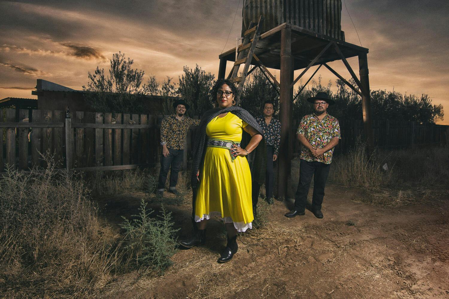 Members of La Santa Cecilia standing in the desert.