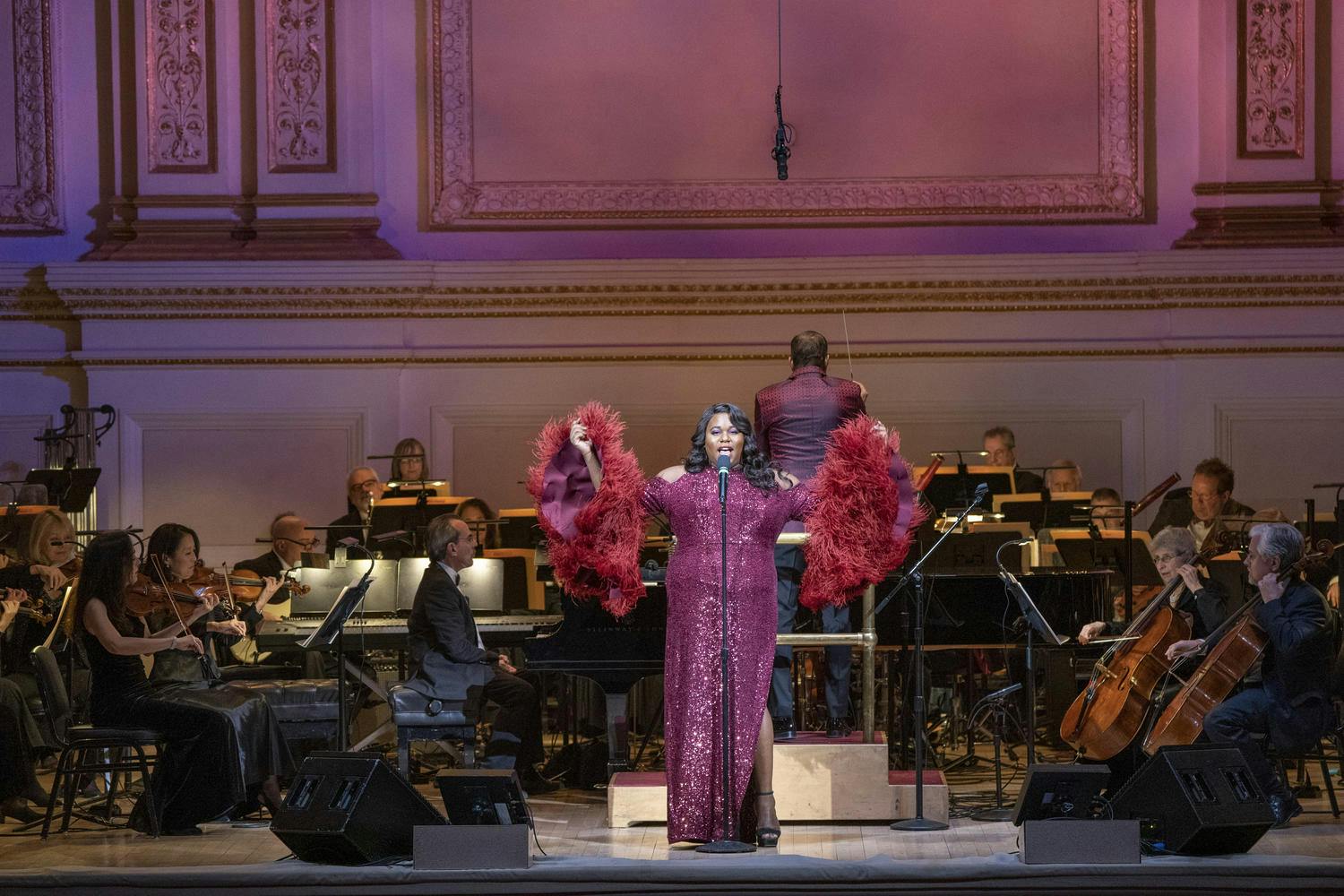 Photo of Alex Newell singing at Carnegie Hall with The New York Pops in the background, 2020.