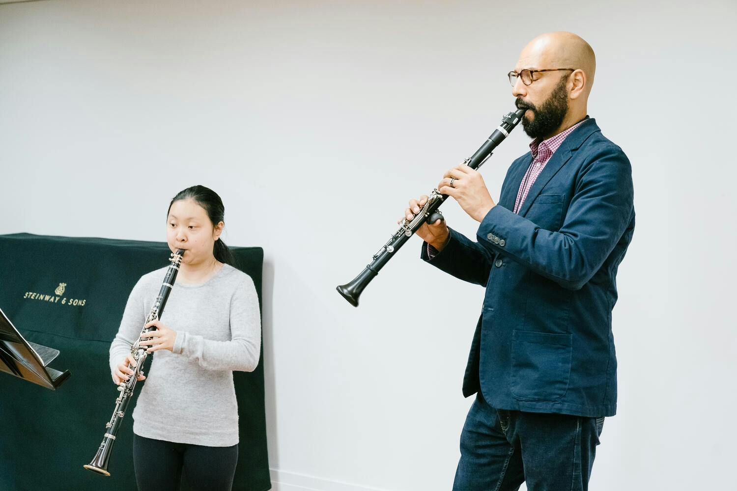 A clarinetist from the Gateways Festival Orchestra engagine in a master class with a student.