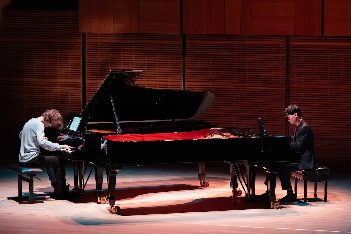 Two pianists from The Juilliard School performing on stage in Zankel Hall.
