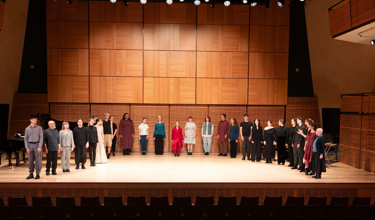 A group photo of students from Juilliard with Meredith Monk on stage in Zankel Hall.