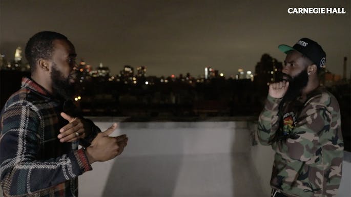 Orson and Shajuan conversing on a rooftop