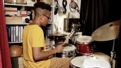 Charles plays drums.