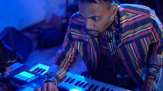 Asante in front of a keyboard with blue lighting