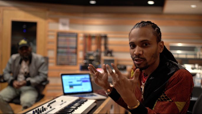 Chen and Asante sitting in a recording studio