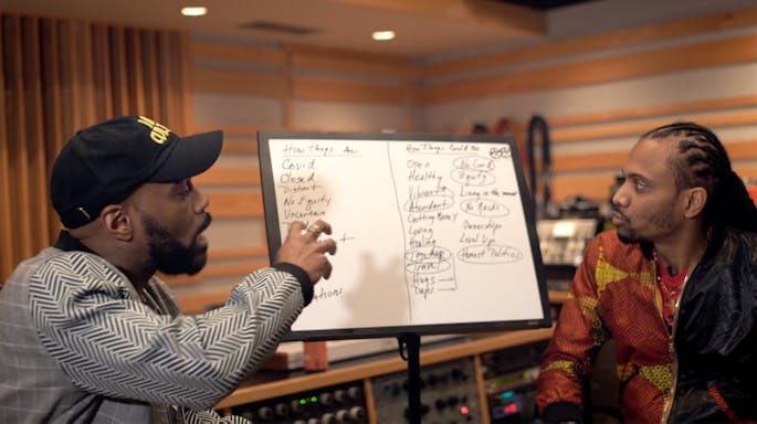 Chen and Asante brainstorming on a whiteboard