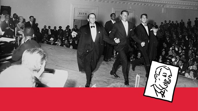 People walking on stage in front of a Carnegie Hall audience