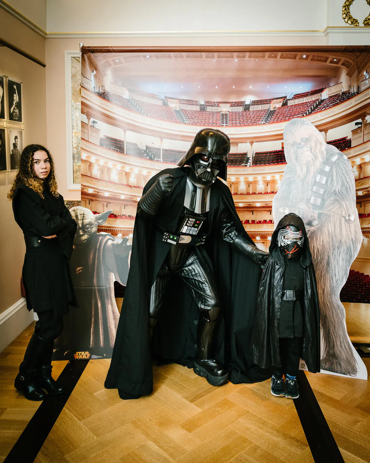 People posing in Star Wars costumes against a backdrop of Carnegie Hall.
