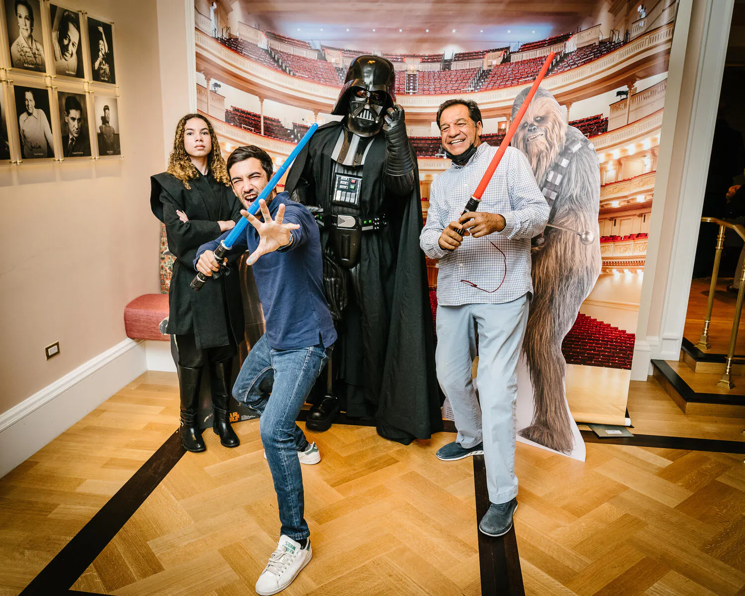 People posing in Star Wars costumes against a backdrop of Carnegie Hall.