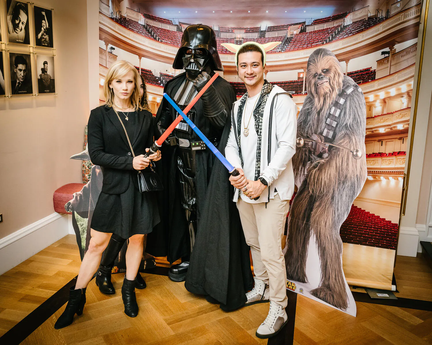 People posing in Star Wars costumes against a backdrop of Carnegie Hall.