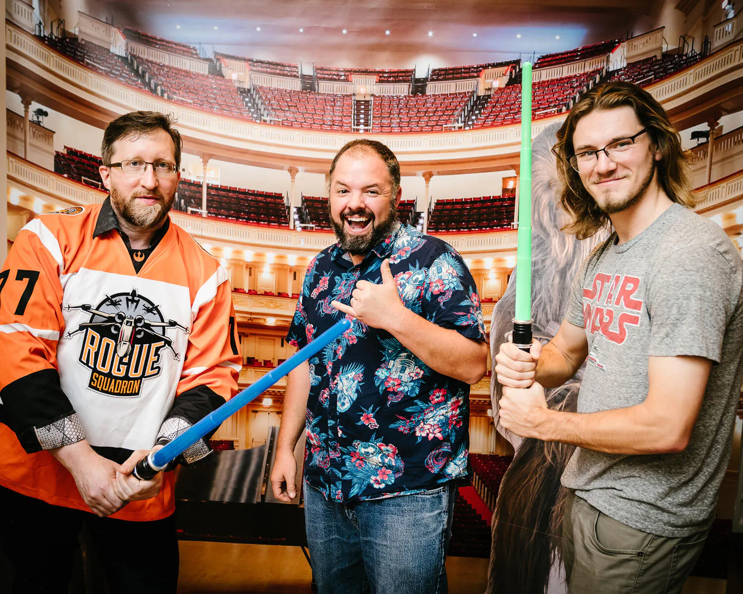 People posing in Star Wars costumes against a backdrop of Carnegie Hall.