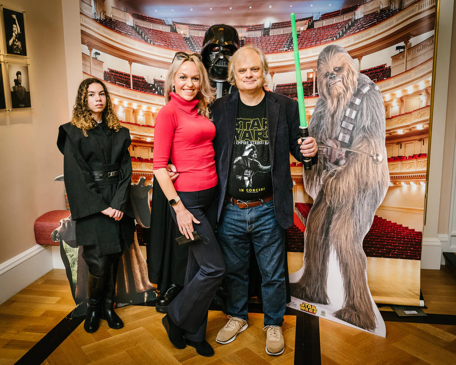 People posing in Star Wars costumes against a backdrop of Carnegie Hall.