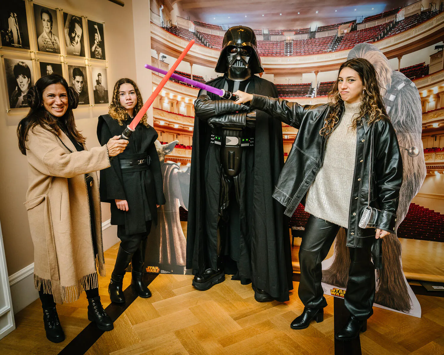 People posing in Star Wars costumes against a backdrop of Carnegie Hall.