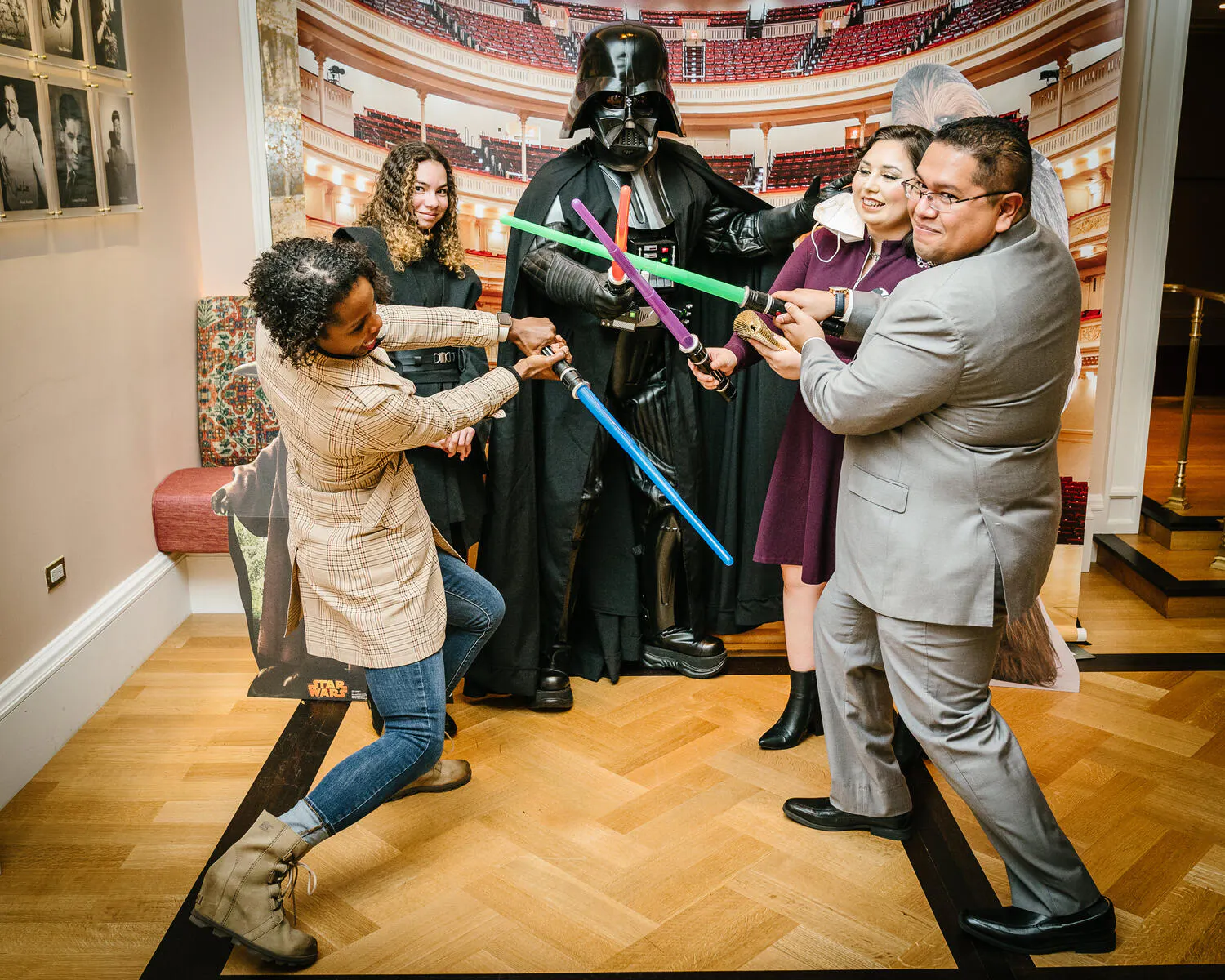People posing in Star Wars costumes against a backdrop of Carnegie Hall.