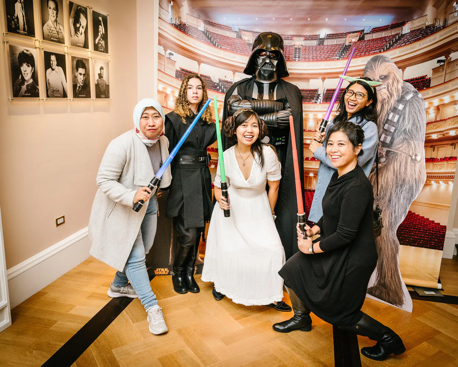 People posing in Star Wars costumes against a backdrop of Carnegie Hall.
