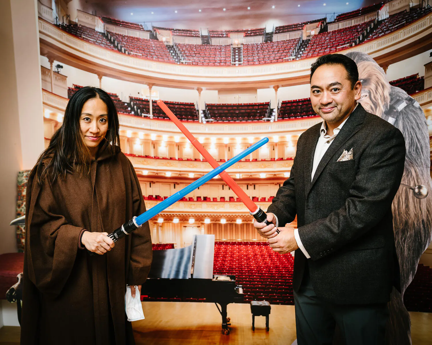 People posing in Star Wars costumes against a backdrop of Carnegie Hall.