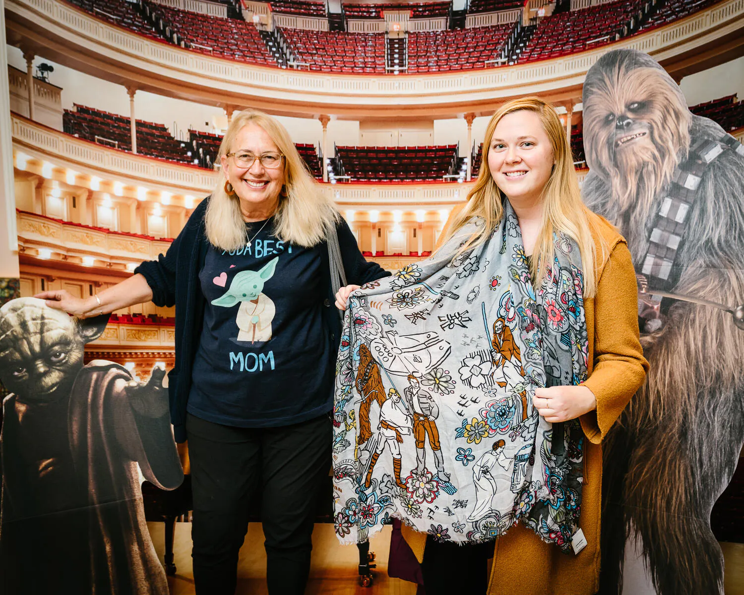 People posing in Star Wars costumes against a backdrop of Carnegie Hall.