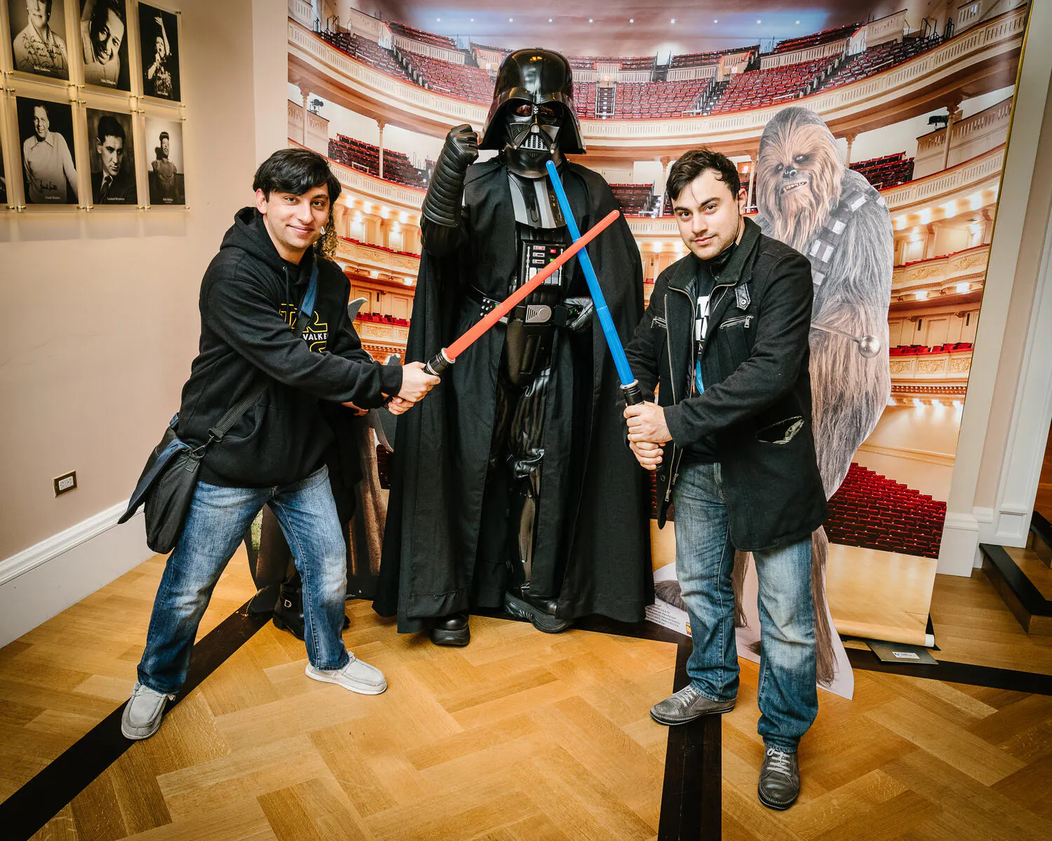 People posing in Star Wars costumes against a backdrop of Carnegie Hall.