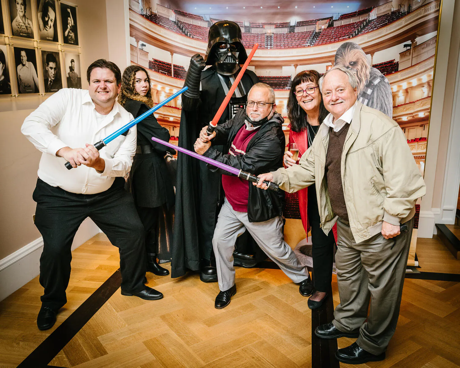 People posing in Star Wars costumes against a backdrop of Carnegie Hall.