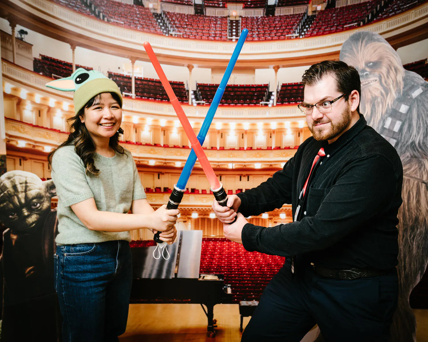 People posing in Star Wars costumes against a backdrop of Carnegie Hall.