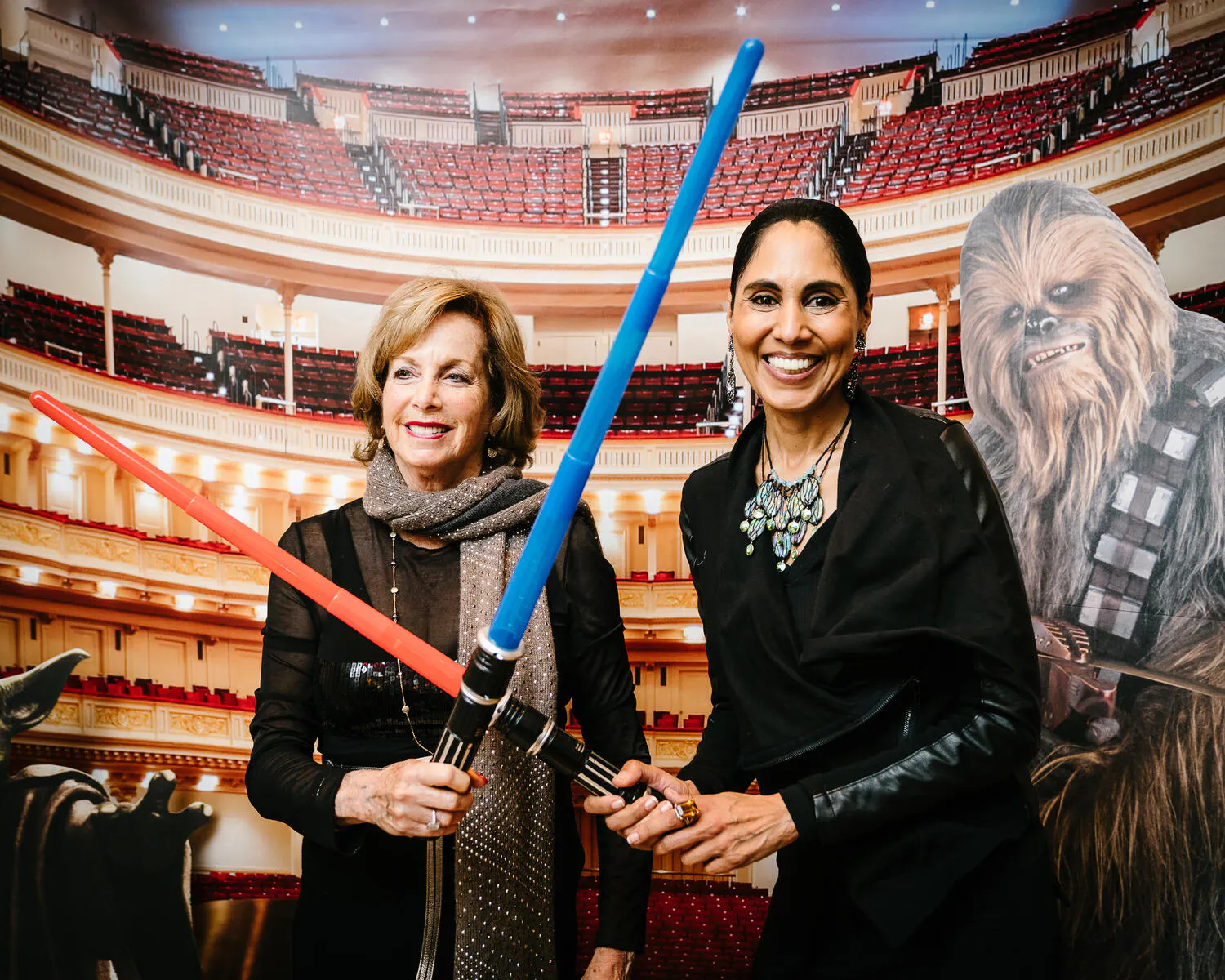People posing in Star Wars costumes against a backdrop of Carnegie Hall.