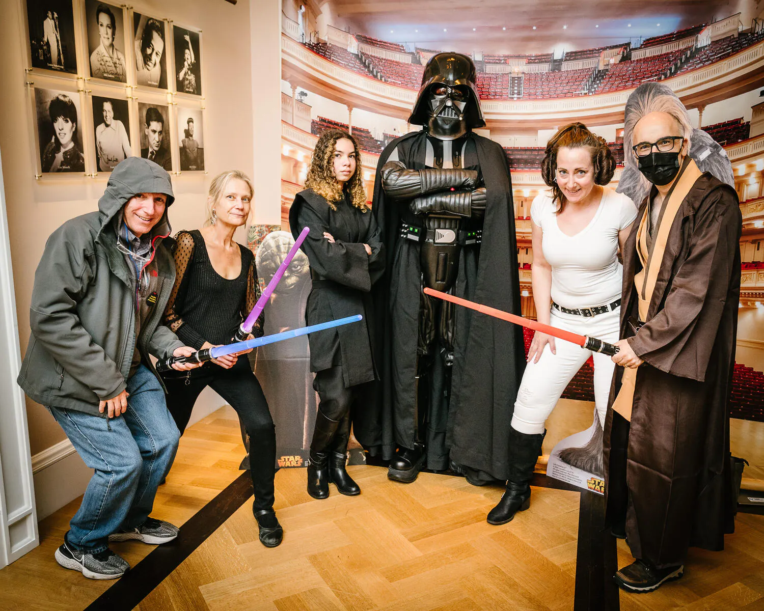 People posing in Star Wars costumes against a backdrop of Carnegie Hall.