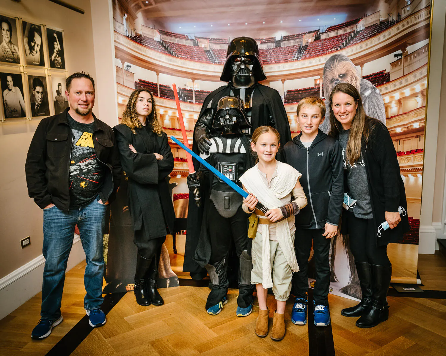 People posing in Star Wars costumes against a backdrop of Carnegie Hall.