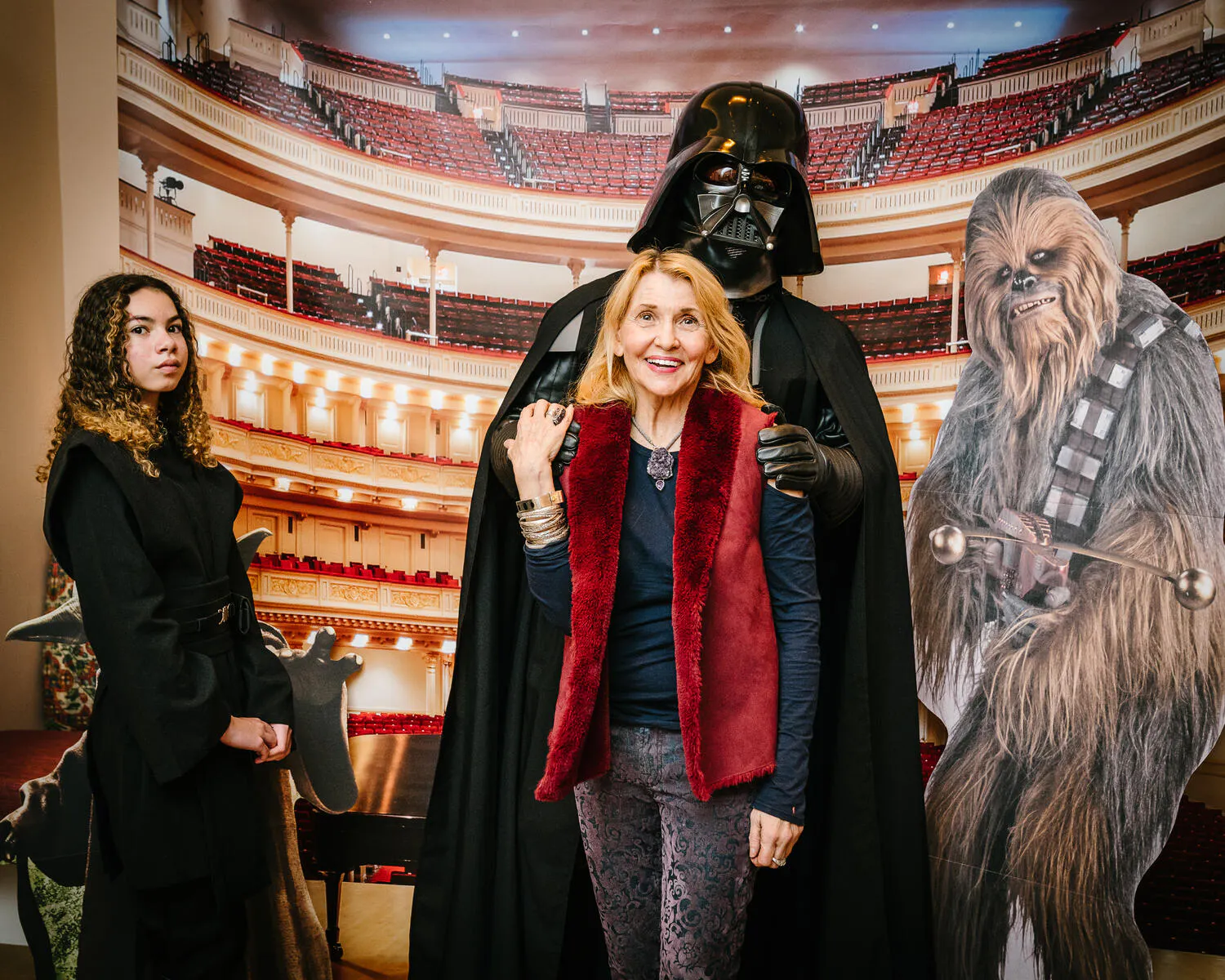 People posing in Star Wars costumes against a backdrop of Carnegie Hall.
