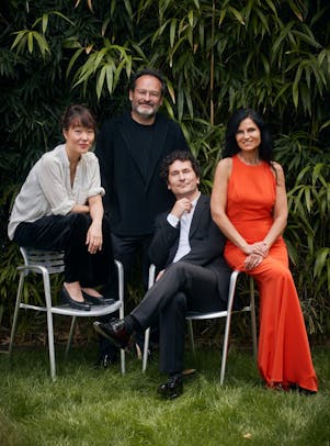 The musicians of Belcea Quartet, two men and two women, pose together on a lawn