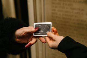 A chocolate shaped like a credit handed between people