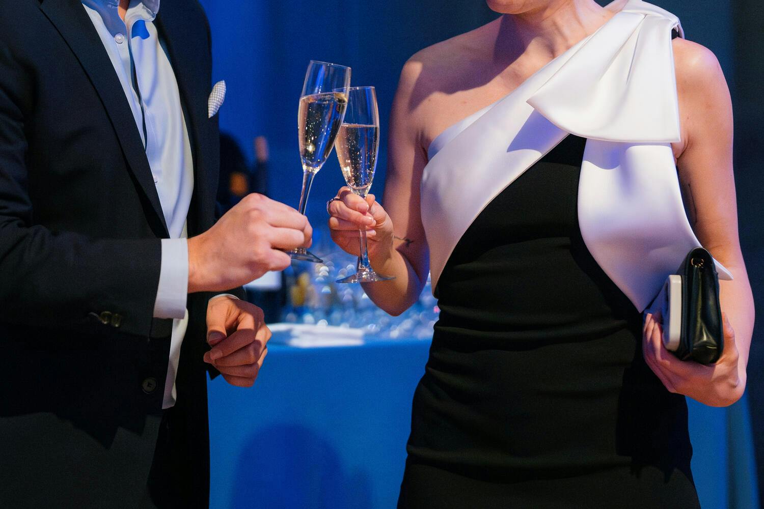 Two people toasting with two glasses of champagne
