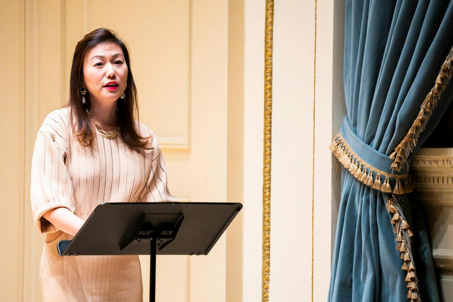 Grace Kim giving remarks at the concert