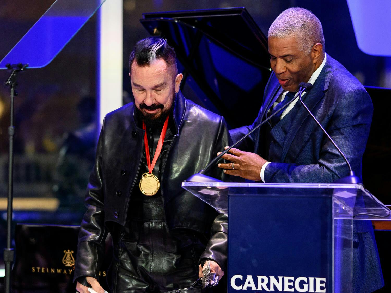Peter Marino accepts the Medal of Exellence from Robert F. Smith