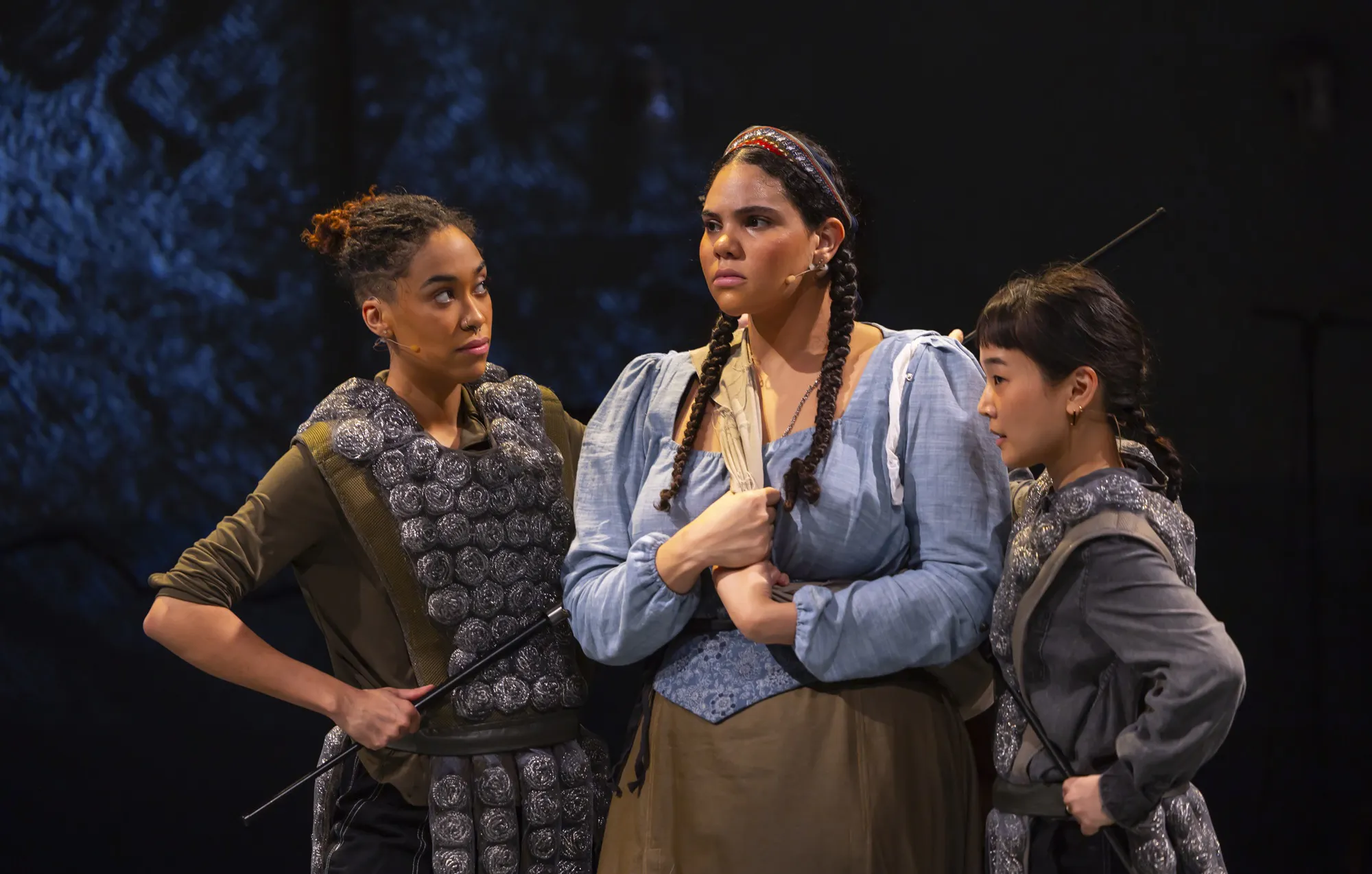 Three performers on stage