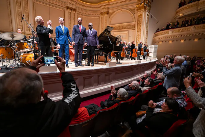 Yannick Nézet-Séguin, the Marcus Roberts Trio, and the Philadelphia Orchestra standing on Perelman Stage in Stern Auditorium