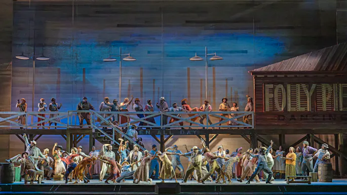 Actors in 1930s period costumes perform on stage