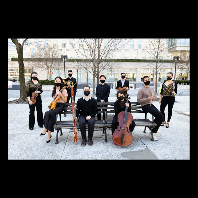 Ensemble Connect wearing masks and holding their instruments around a park bench