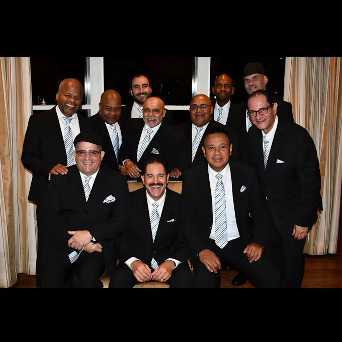 Son Del Monte posing in matching black and white suits and ties