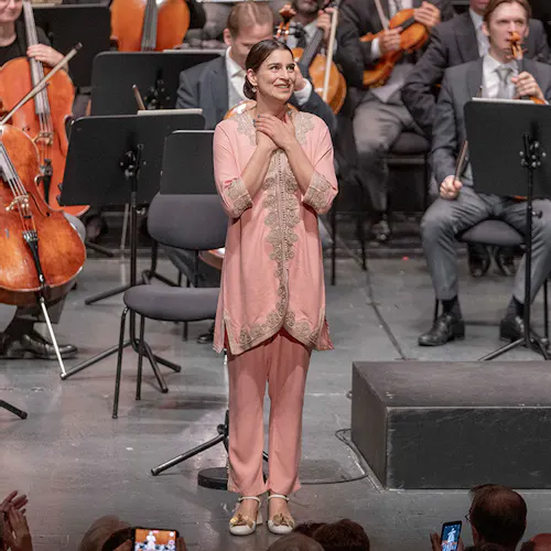 Asmik Grigorian standing on stage for applause.