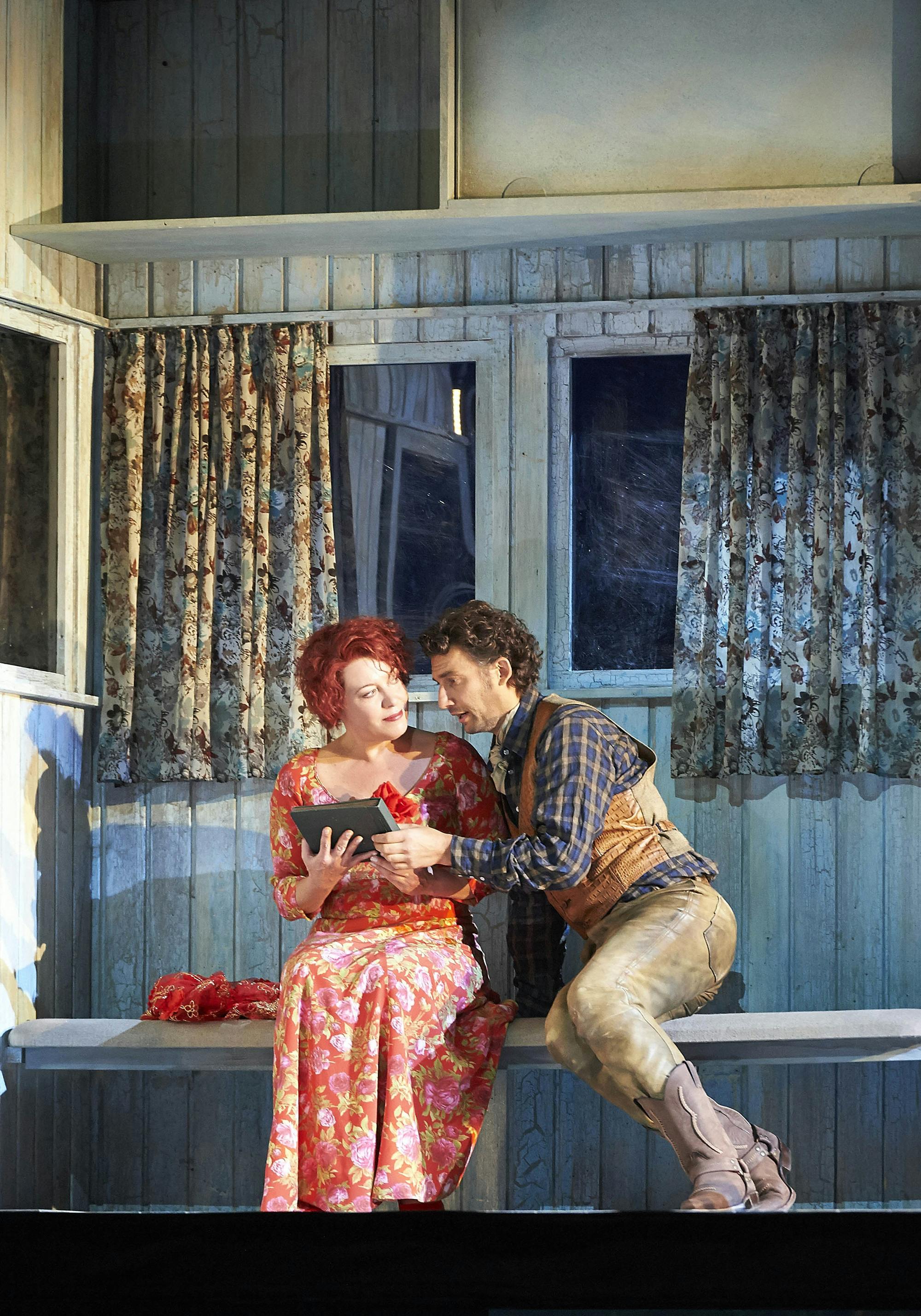 Jonas Kaufmann leaning toward Nina Stemme as she holds a book.