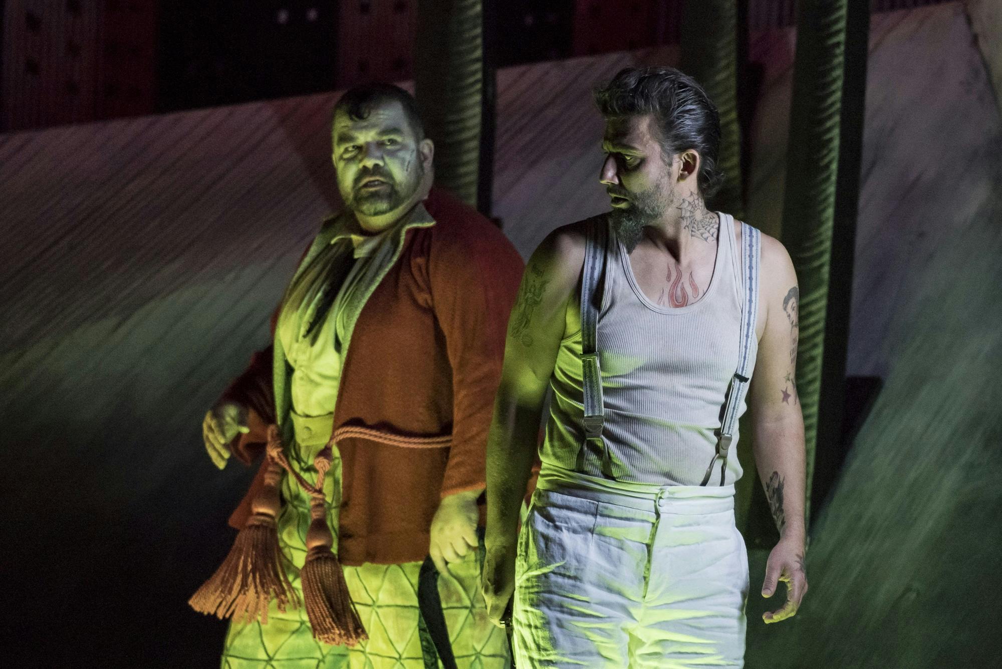 Jonas Kaufmann standing and looking to the left at Dimitri Platanias.